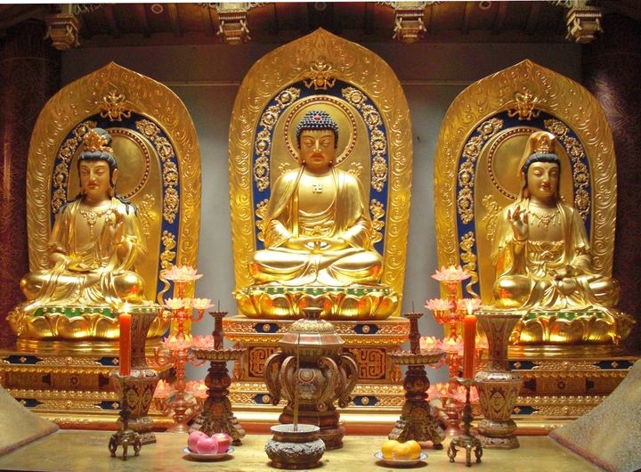 Golden statues of Amitabha Buddha (center) with his attendants Avalokitesvara Bodhisattva and Mahasthamaprapta Bodhisattva