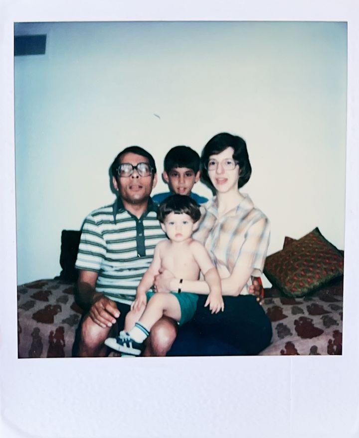 Scanned Polaroid photo of a South Asian man, a white woman, and their 9- and 1-year-old sons.