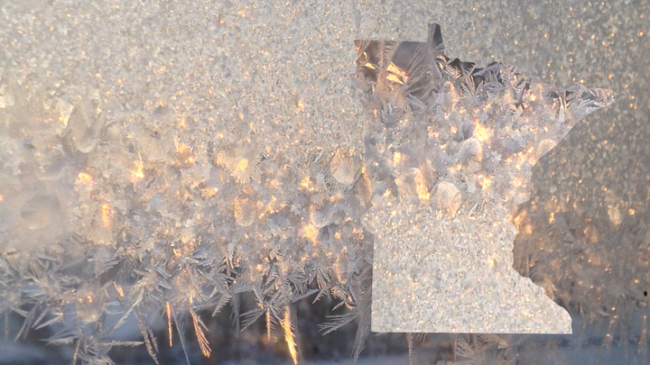 A photo collage of the silhouette of Minnesota against a frost crystals on a window.